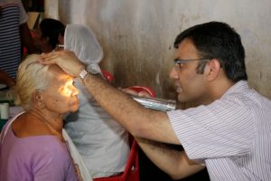A doctor checks a patient's eyes